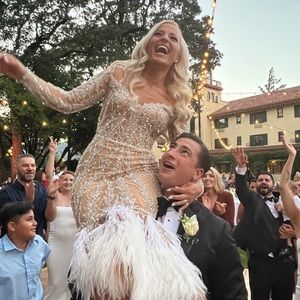 Albina Dyla sheer lined custom dress with white feathers.